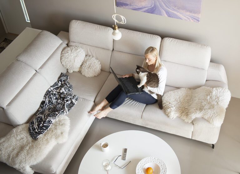 Mature woman and cute cat talking through video chat with her children who are in isolation during the coron virus covid-19 pandemic